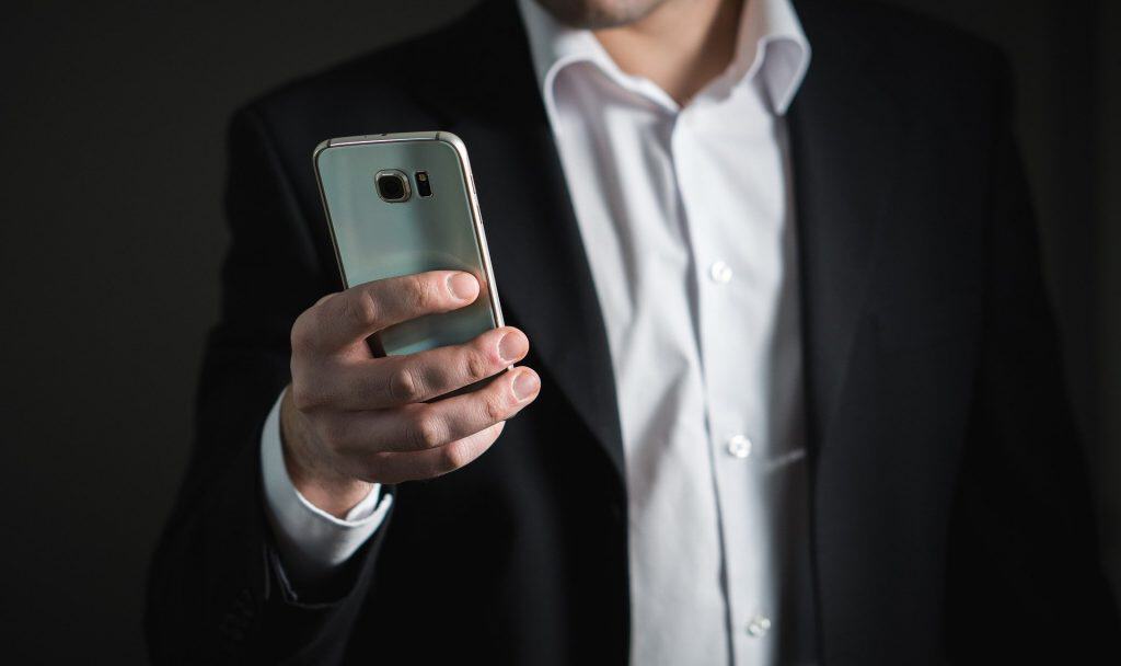 business man looking at his mobile