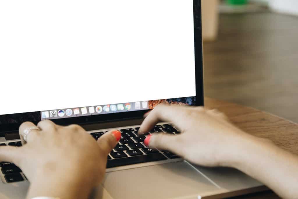 woman typing on laptop