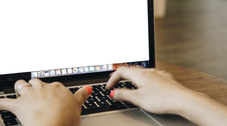 woman typing on laptop