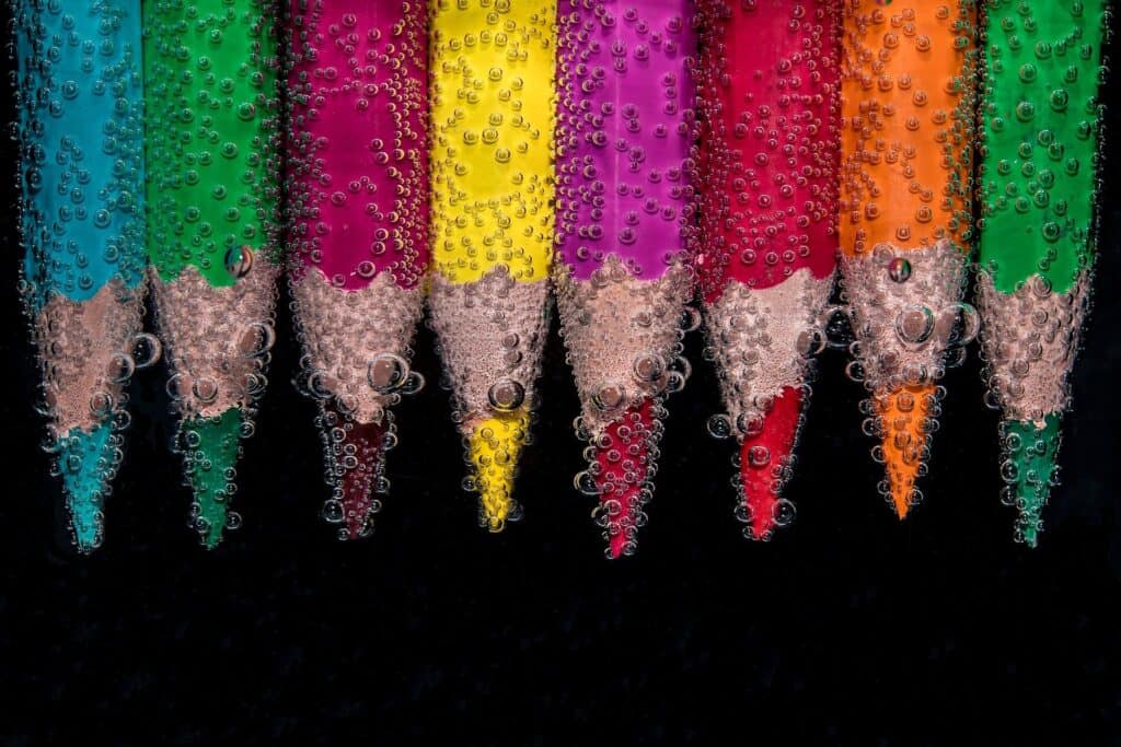 coloured crayons in water